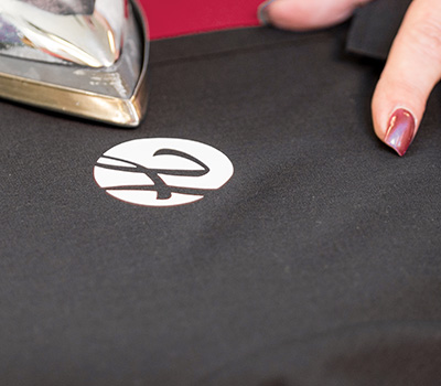 Bügeln eines Stoffes mit dem Logo drauf